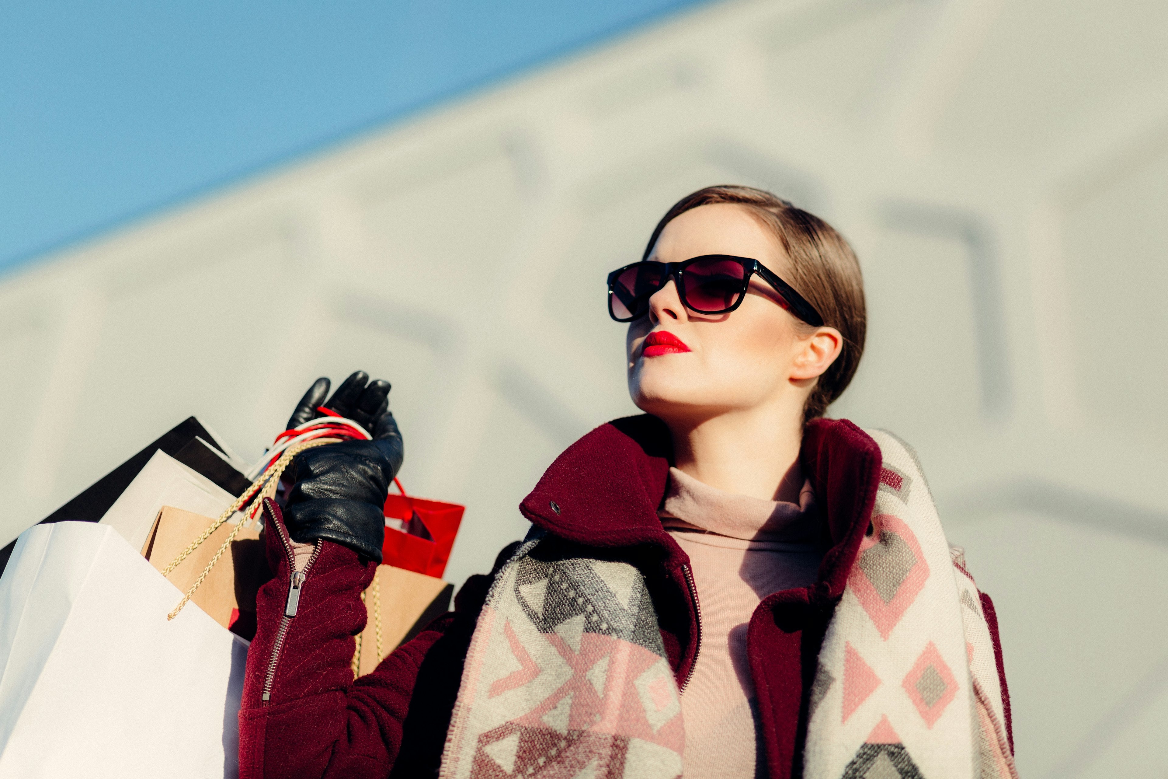Woman walking with premium shopping bags, luxury lifestyle